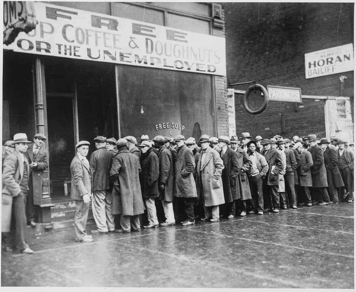 2048px Unemployed men queued outside a depression soup kitchen opened in Chicago by Al Capone 02 1931   NARA   541927 2
